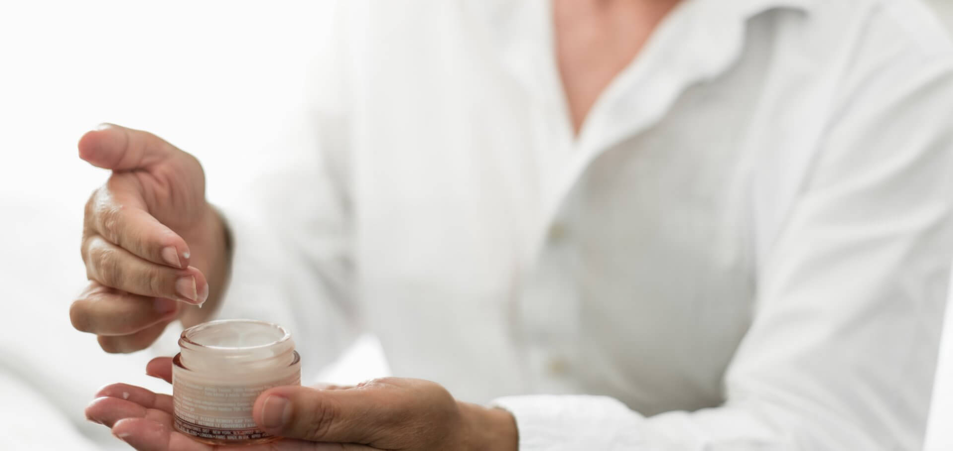 woman using skin cream