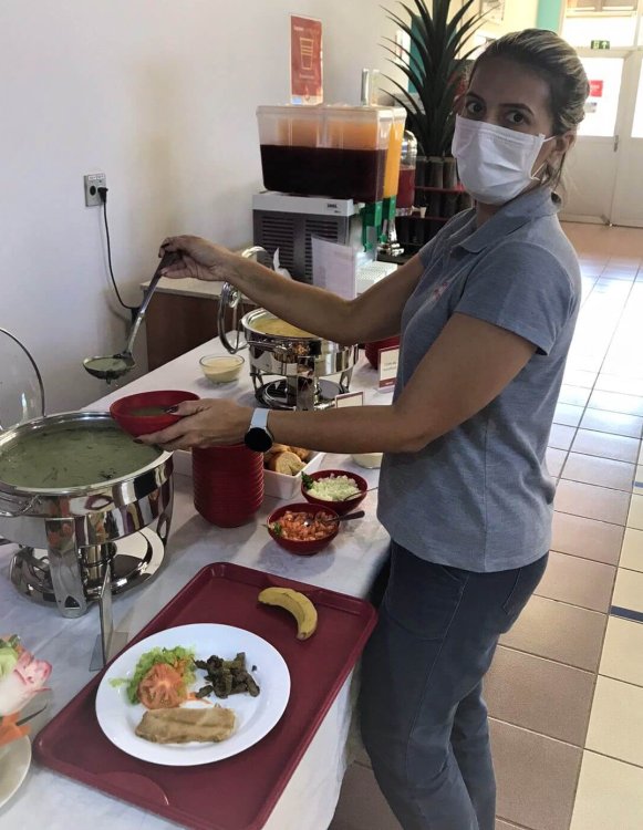 Kelly Martins serves herself lunch in an ABR cafeteria.